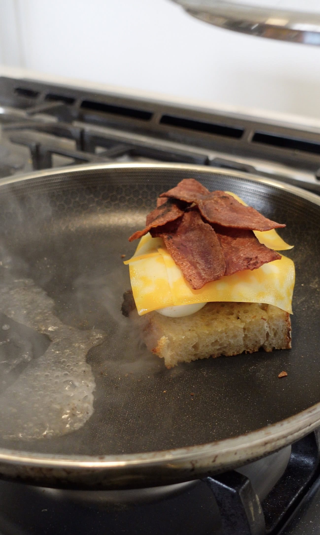 Bacon and cheese on top of a Deviled Egg on toast.